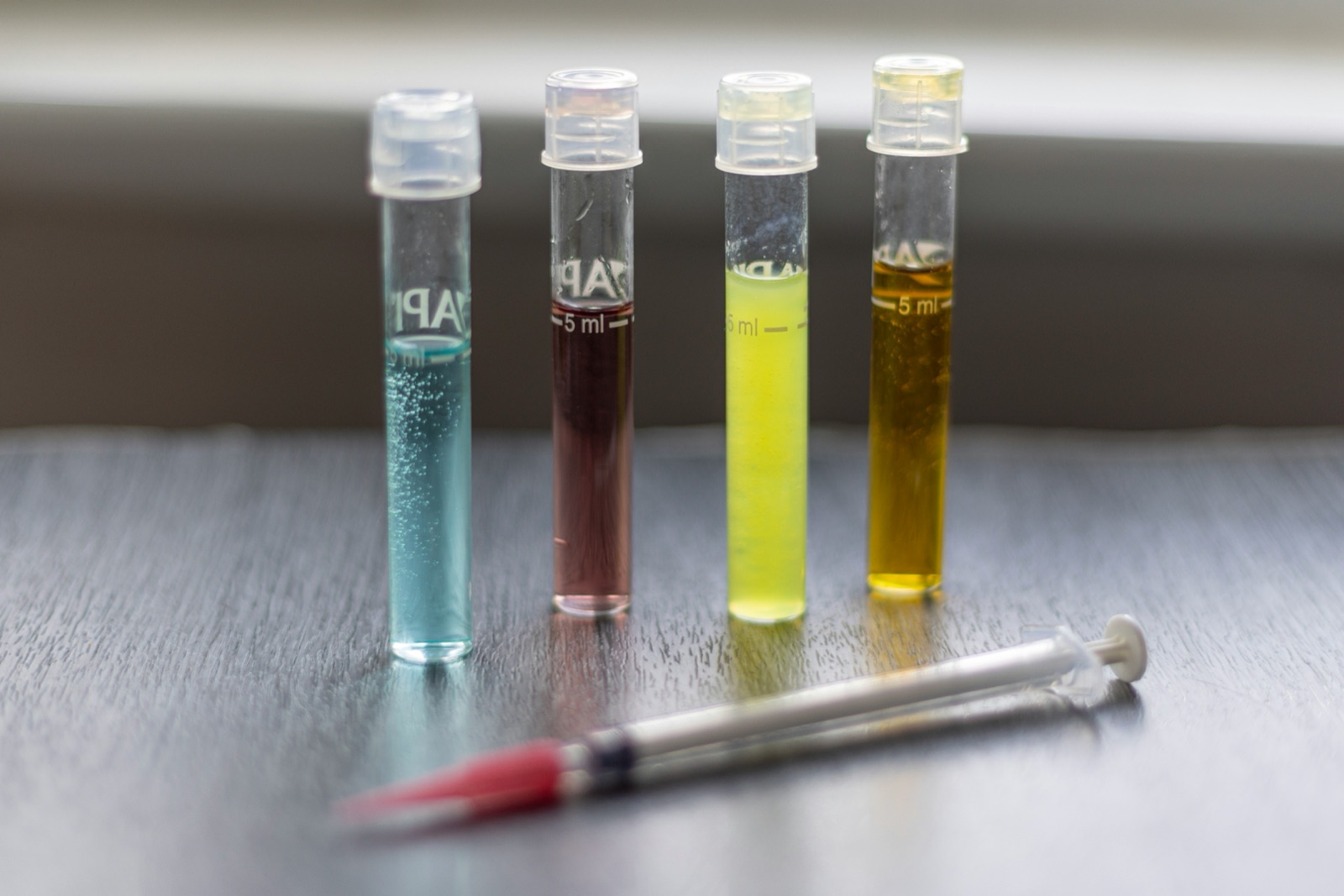 Test tubes with liquid samples for cyanoacrylate wide viscosity selection 1 cP to 3000 cP