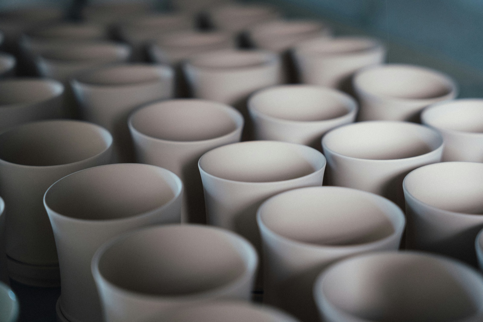 Rows of unglazed ceramic cups in workshop for Epo-Weld™ high emissive ceramic coating dense refractory and crucible