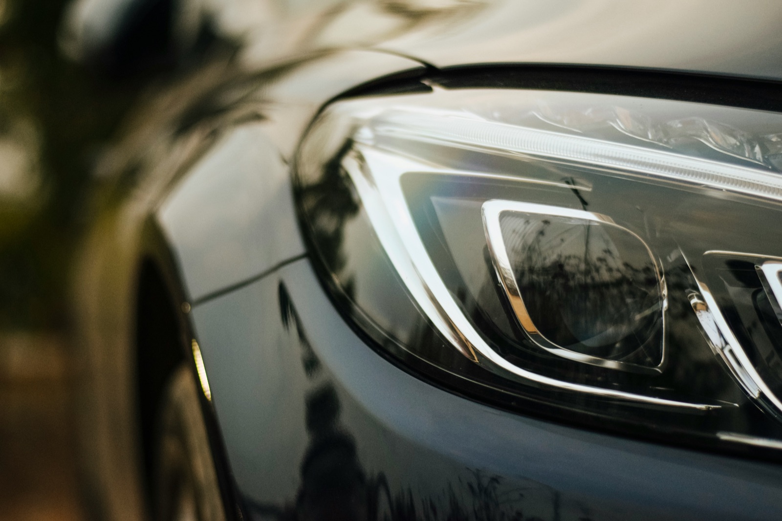 Gray car with white and blue headlights for Epo-Weld™ UHTC ultra high temperature coating automotive headlamp assembly