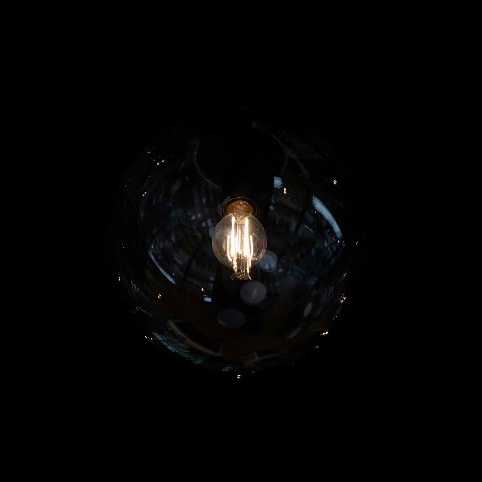 Light bulb glowing inside a glass sphere for Epo-Weld™ UHTC ultra high temperature coating uncoated glass headlamp