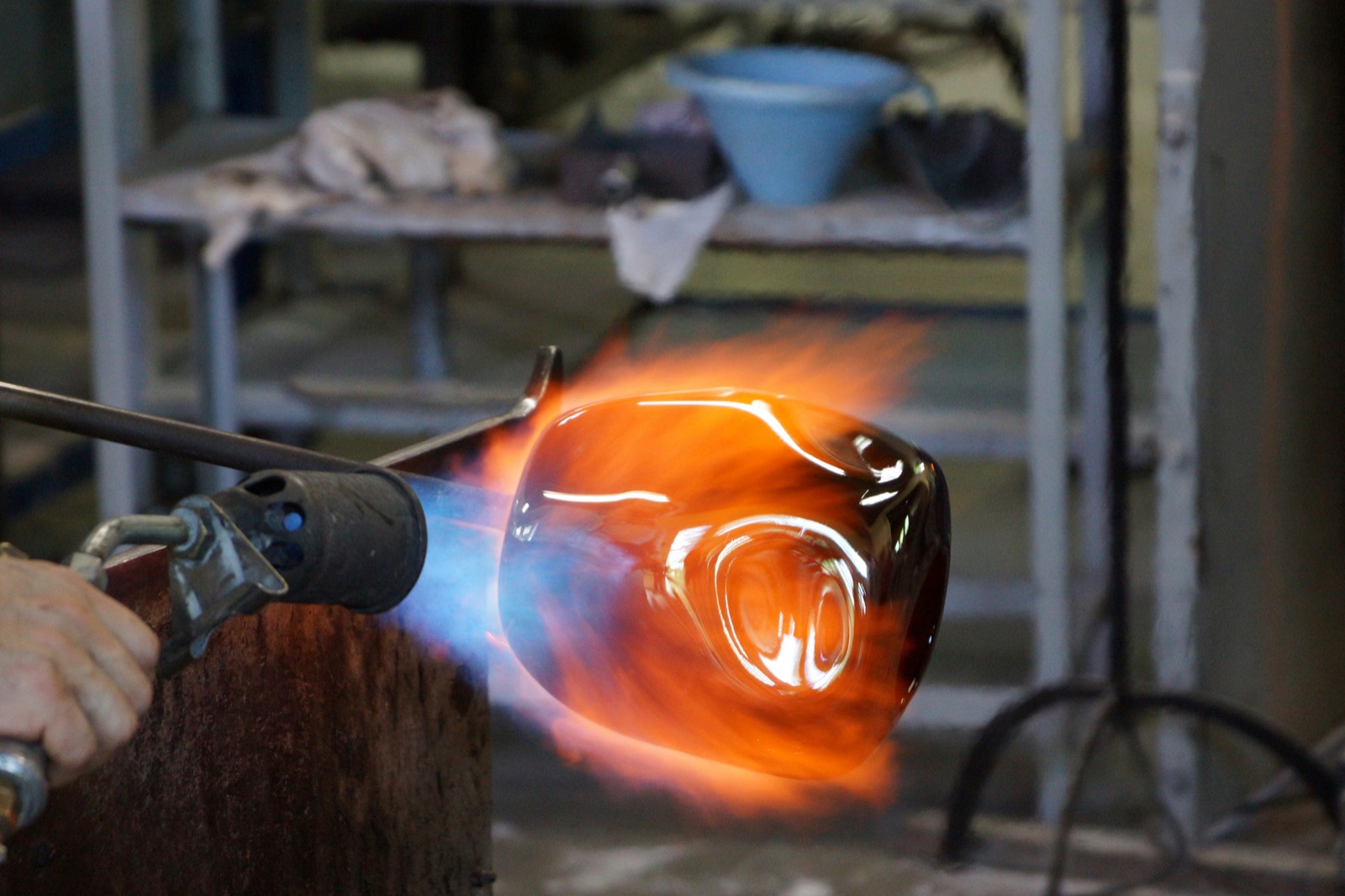 Craftsman shaping molten glass with torch for Epo-Weld™ inorganic binder quartz tube and lamp sealing