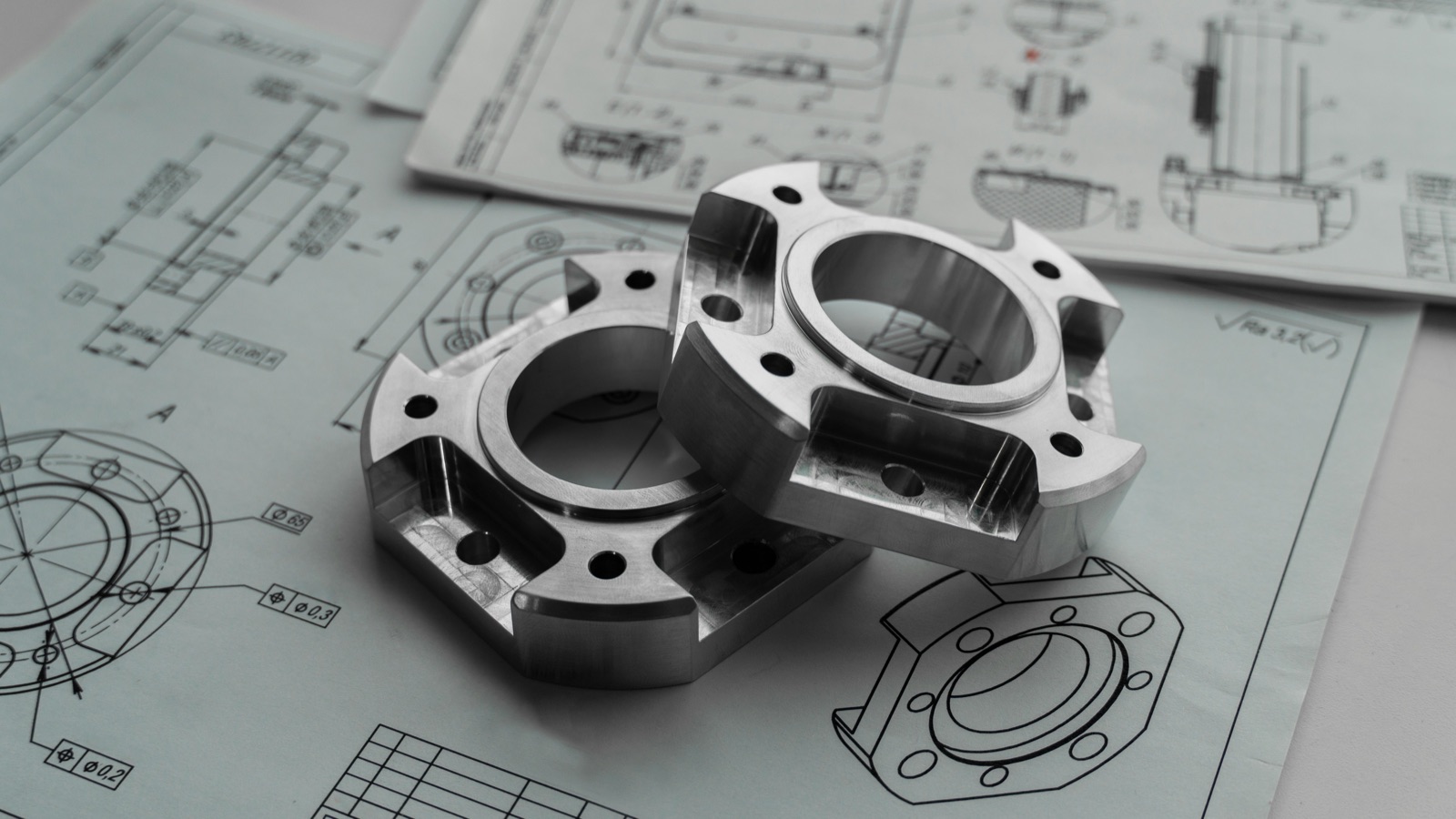 Precision metal parts on engineering blueprints for Pyra-Sil™ peelable silicone prototype and tooling protection