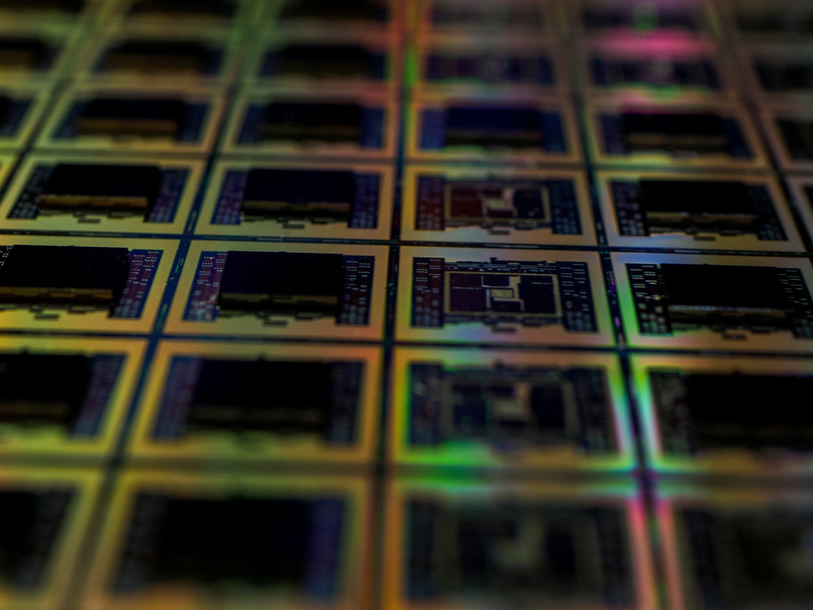 Silicon wafer with iridescent die array close-up for Incure Sniper™ dispensing needle semiconductor underfill epoxy