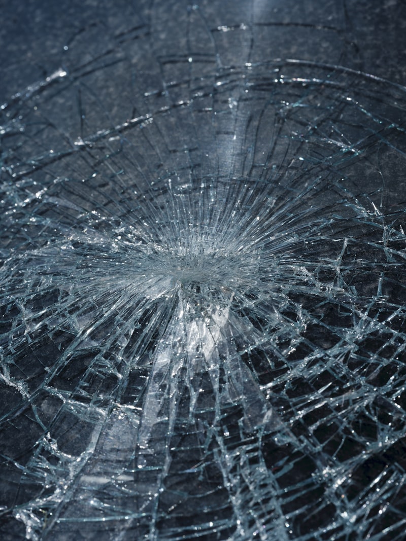 Rock impact point on shattered windshield glass for Uni-Weld™ UV automotive glass repair