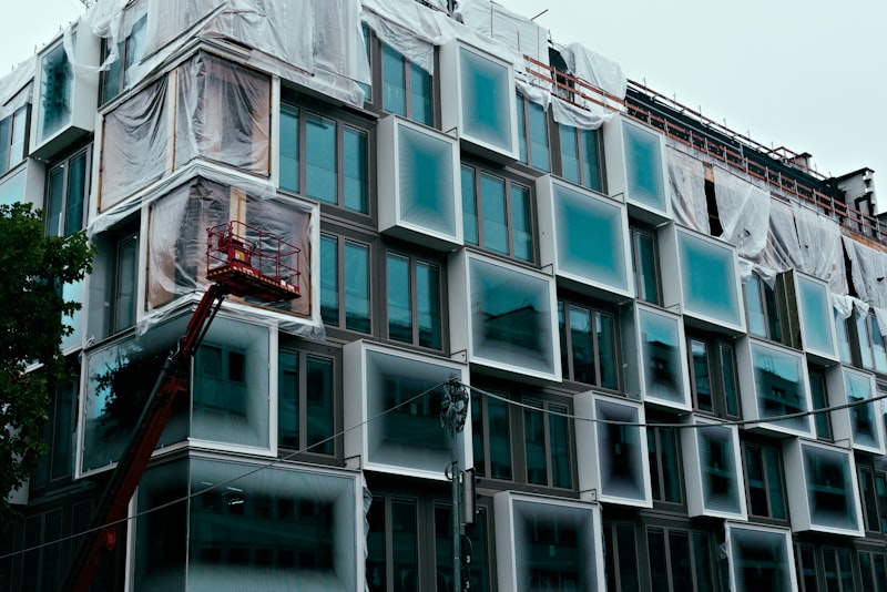 Glass building facade under construction with large window panels for Uni-Weld™ vertical glass bonding and dam-fill