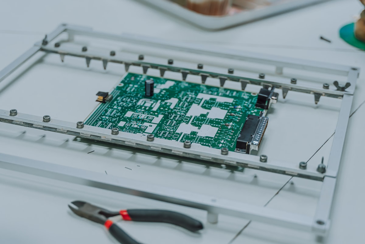 Green circuit board with electronic components for Litemask™ UV maskant PCB connector and test point protection before