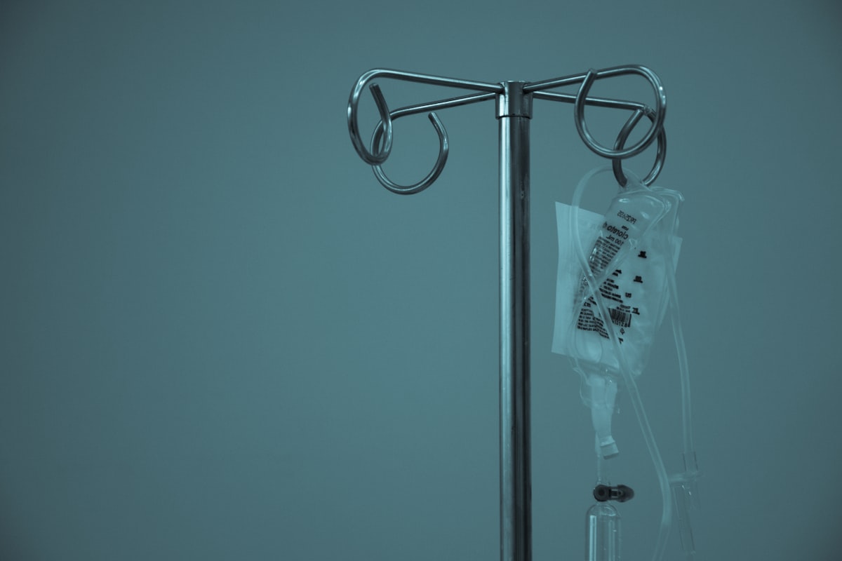 Dextrose bag on stainless steel IV stand in clinical setting for Cyro-Weld™ UV medical adhesive blood reservoir